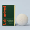 Kate McLeod Breathe Stone lotion bar and packaging on a light blue background