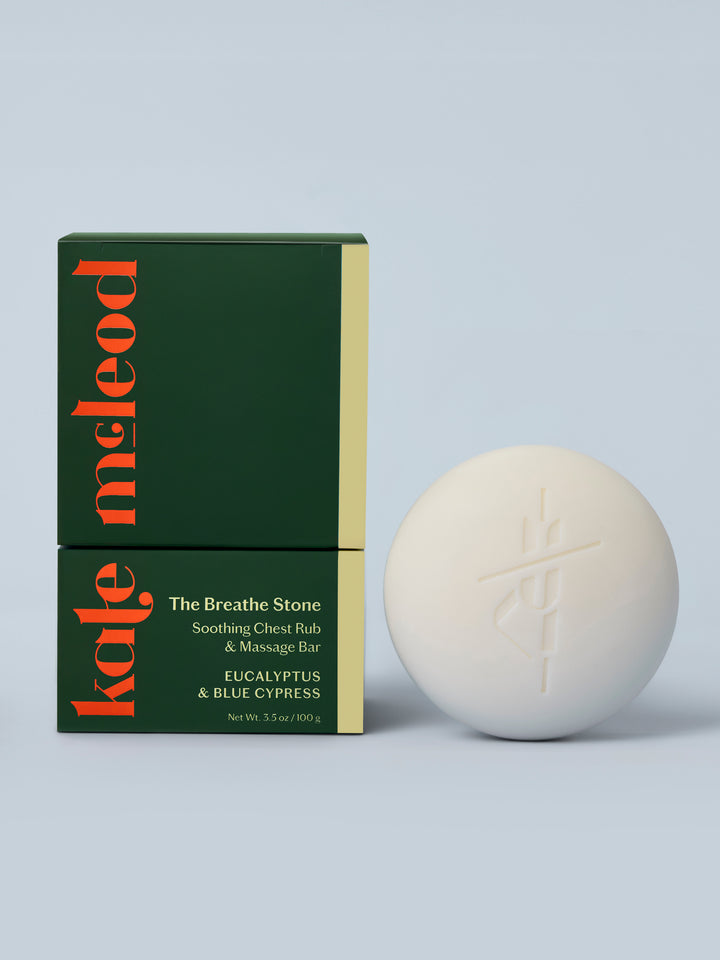 Kate McLeod Breathe Stone lotion bar and packaging on a light blue background