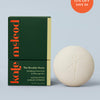 Kate McLeod Breathe Stone lotion bar and packaging on a light blue background