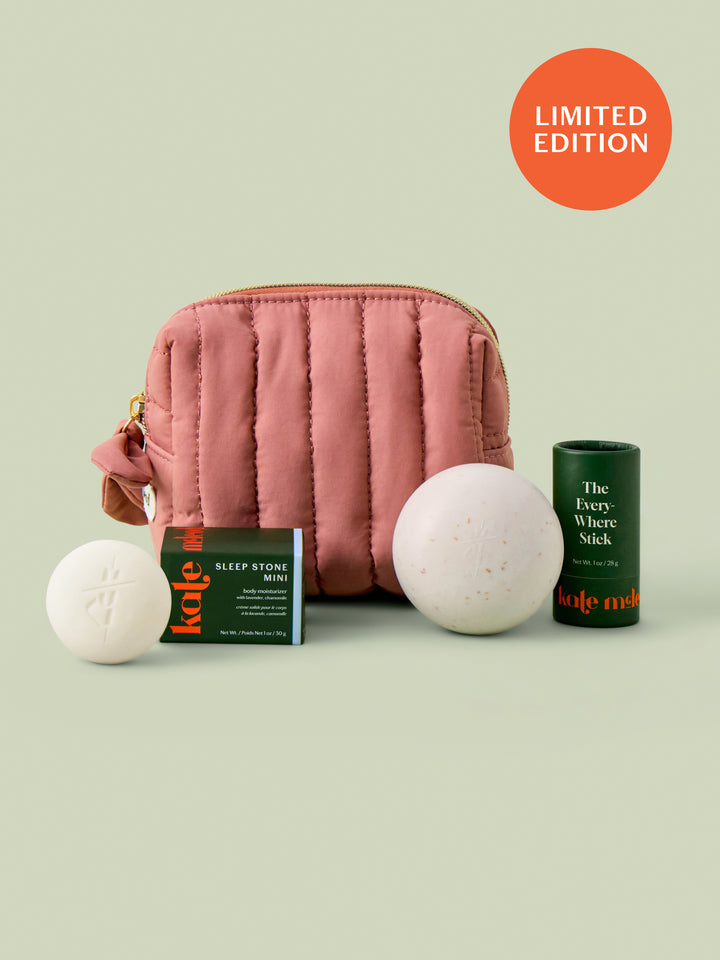 Mini travel bag in limited-edition blush that includes the sleep stone mini and everywhere stick shown on a light green background.