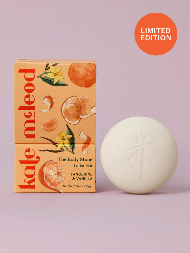 Kate McLeod Tangerine & Vanilla lotion bar with packaging on a light purple background
