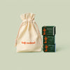 The Kate McLeod Gift Bag styled alongside three mini stones in green boxes on a light green background.
