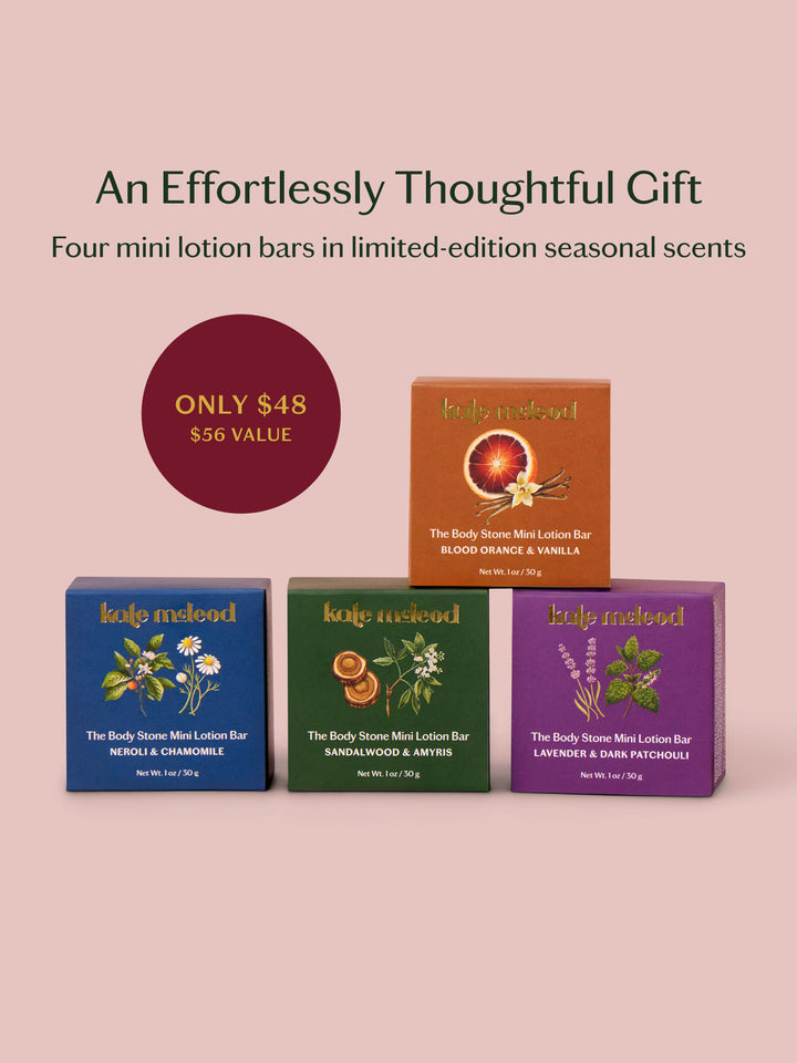 Four mini lotion bar boxes from kolo natural on a dusty pink background with promotional text. The boxes are blue, green, purple, and orange-brown, each with botanical illustrations and product names including Neroli & Chamomile, Sandalwood & Ambers, Lavender & Dark Patchouli, and Blood Orange & Vanilla.