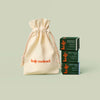 Mini Gift Bag with a stack of 3 Mini Body Stones next to it. The Mini Gift Bag fits up to 3 Mini Body Stones.