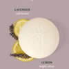 The Lavender Lemonade Body Bar with lemon slices and lavender on a light lavender background