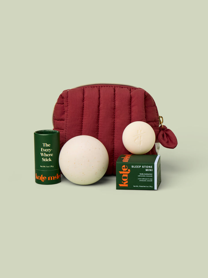 Mini Travel Bag in Wine with Everywhere Stick, Mini Travel Case, and Mini Sleep Stone. These items fit into the Mini Travel Bag.