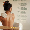 Person in a bathtub with a Body Mitt, surrounded by text about water-activated plant-based moisture and Pebble ingredients. Cocoa butter, jojoba oil, baobab oil, kukui nut oil, plus baking soda & citric acid to gently exfoliate.