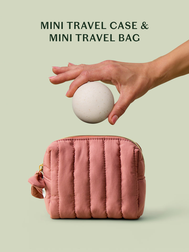 The limited-edition blush travel bag alongside a the mini travel case for a size comparison on a light green background.