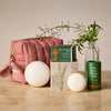 The complete jet set that includes the limited-edition mini travel bag in blush, the travel case, the mini sleep stone and the everywhere stick.