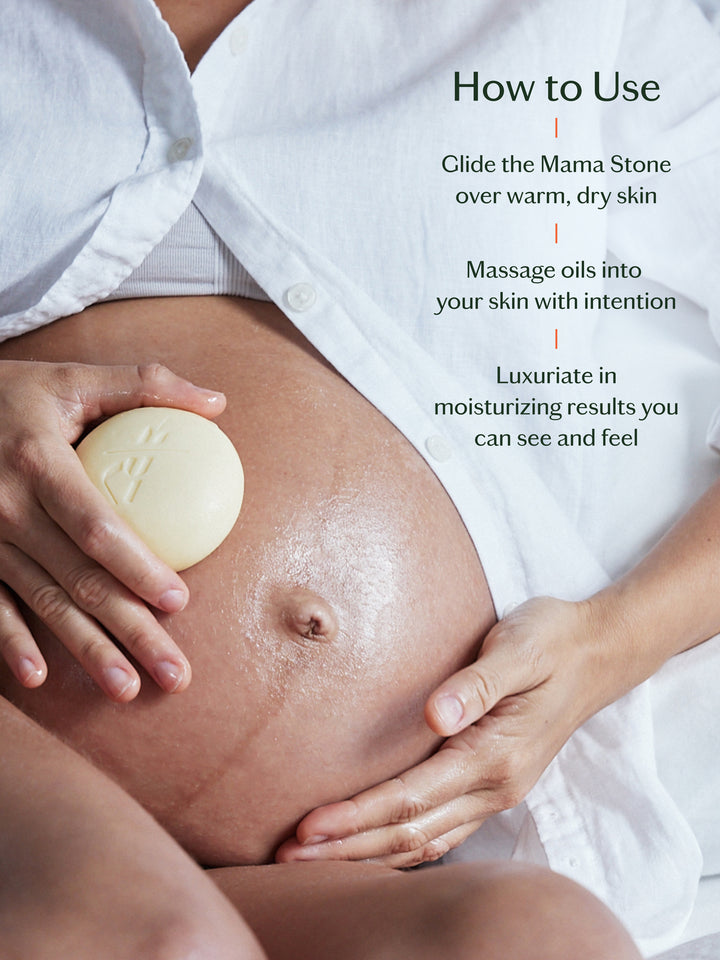 Person using a Mama Stone on their pregnant belly with text instructions.