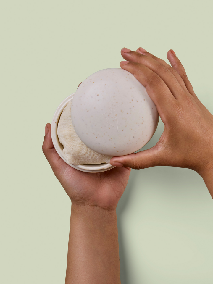 Hands opening up a Full-Size Travel Case in ivory color to reveal a Body Stone.