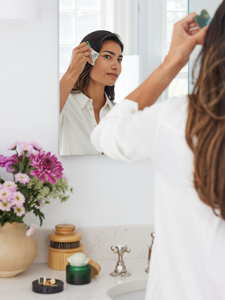 A model using the Face Gua Sha on her cheek.