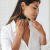 A model using the Face Gua Sha on her neck and jaw.