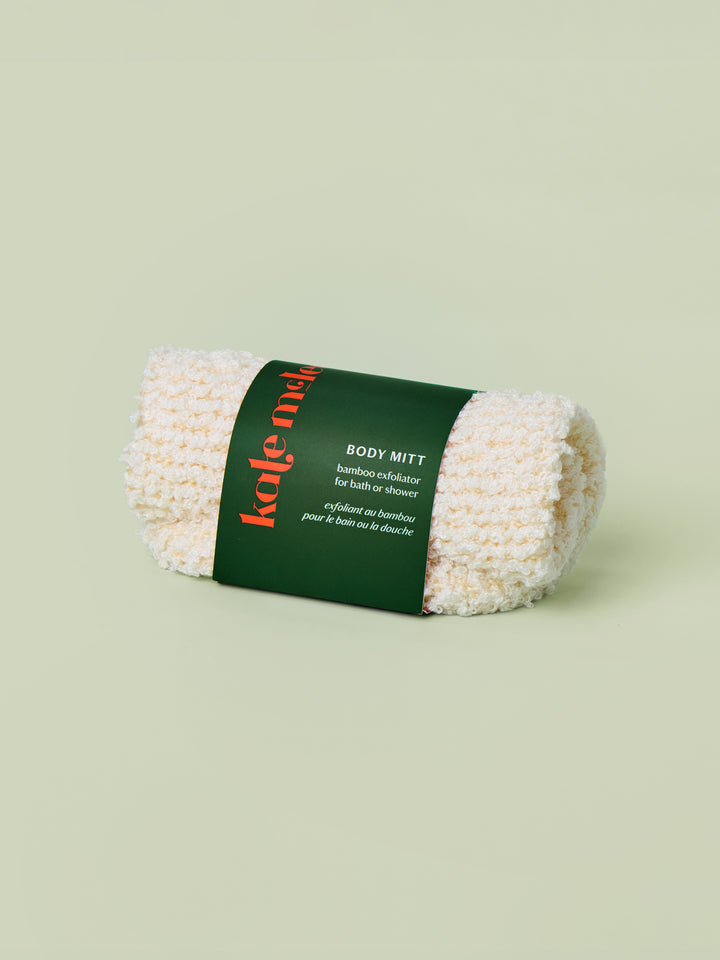 Body Mitt rolled up with green label on a light green background.