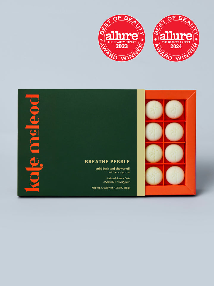 Grid Boxed Packaging for the Breathe Pebble Solid Bath and Shower Oil with Eucalyptus with Grey Blue Background