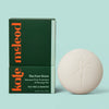 Kate Mcleod Foot Stone and packaging on a light teal background