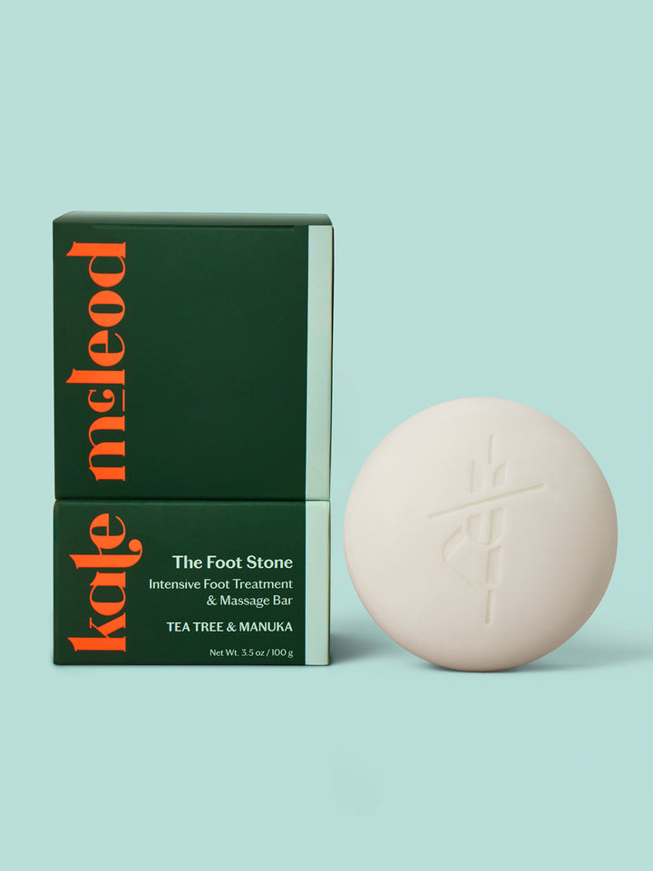Kate Mcleod Foot Stone and packaging on a light teal background