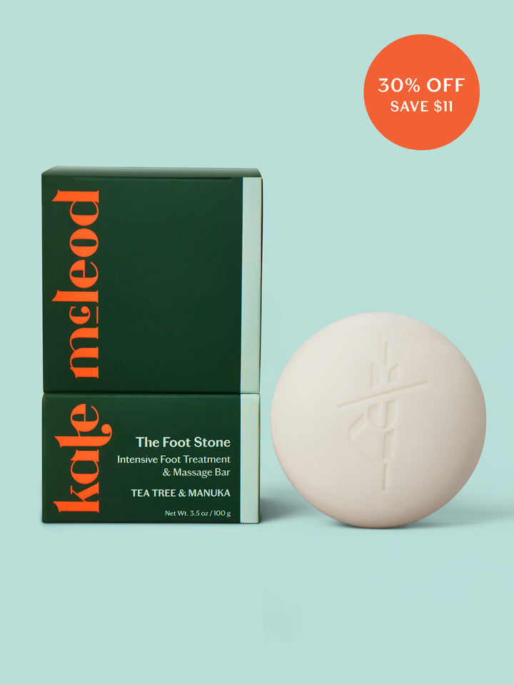 Kate Mcleod Foot Stone and packaging on a light teal background