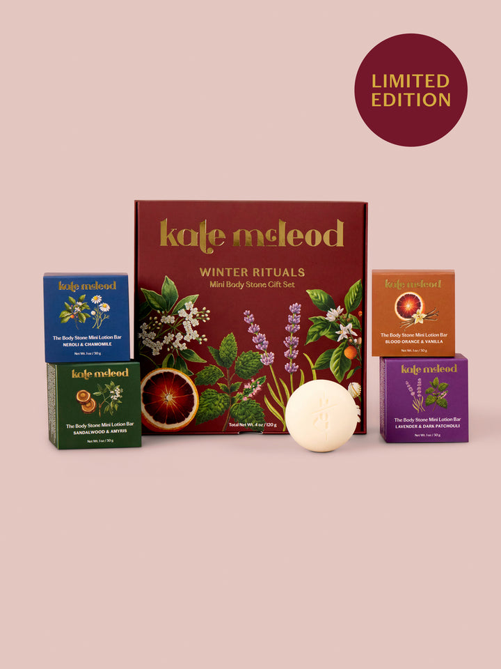 Kale McLeod Winter Rituals mini body ritual gift set on a dusty pink background, featuring a central dark red box with botanical illustrations, three smaller colored boxes, and a round white bar of soap in front. A dark red circle in the top right reads 'LIMITED EDITION'.