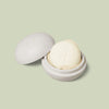 Mini Travel Case in ivory color laying open with a mini Body Stone nestled inside on a light green background.