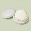 Full-Size Travel Case in ivory color laying open with a full-size Body Stone nestled inside on a light green background.