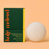 Kale McLeod Recovery Stone lotion bar and packaging on a peach background
