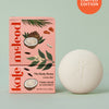 Kate McLeod Tonka Bean & Coconut lotion bar with packaging on a light green background