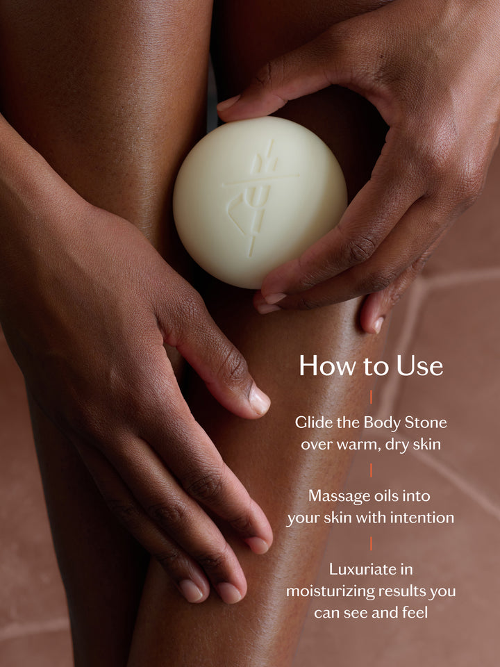 Person holding a white Body Stone with text on how to use it.