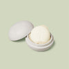 Mini Travel Case in ivory oatmeal color laying open with a mini Body Stone nestled inside on a light green background.