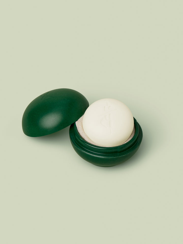 Mini Travel Case in Pine Green with a white mini Body Stone nestled inside.