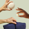 Hands holding up the set components against light green background