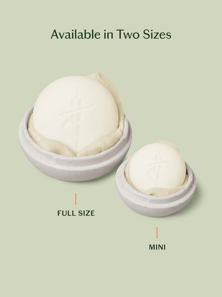 A side-by-side comparison of the full size travel case next to the mini travel case in the color oatmeal on a light green background.