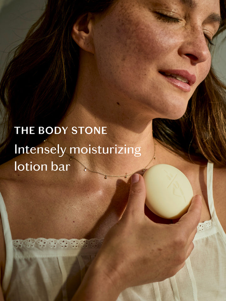 Woman holding a lotion bar with text about intensely moisturizing lotion bar.