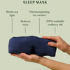 Lunya washable silk sleep mask held by a hand with features listed on a light green background