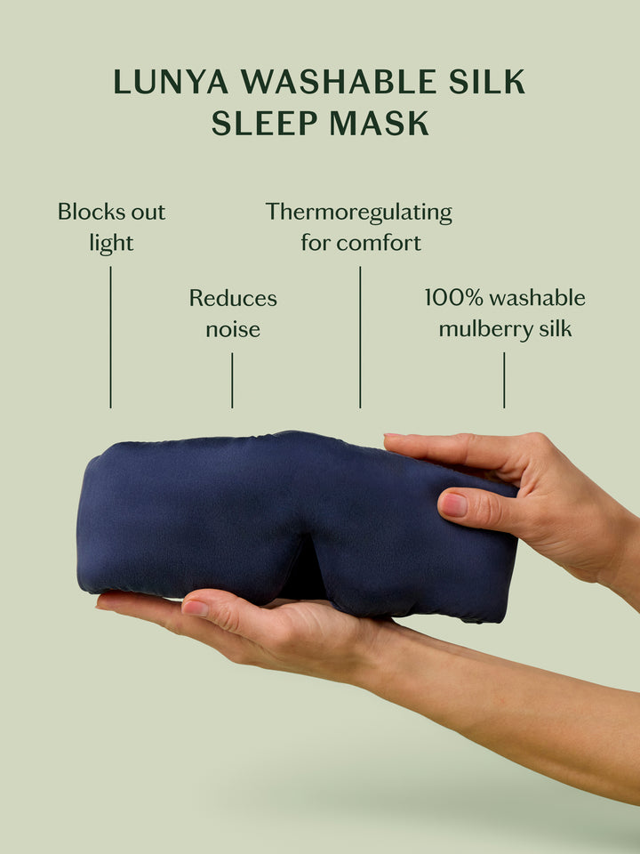 Lunya washable silk sleep mask held by a hand with features listed on a light green background