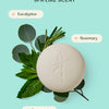 Refreshing, spa-like scent. The foot stone overlayed on top of eucalyptus, rosemary and peppermint on a light teal background.