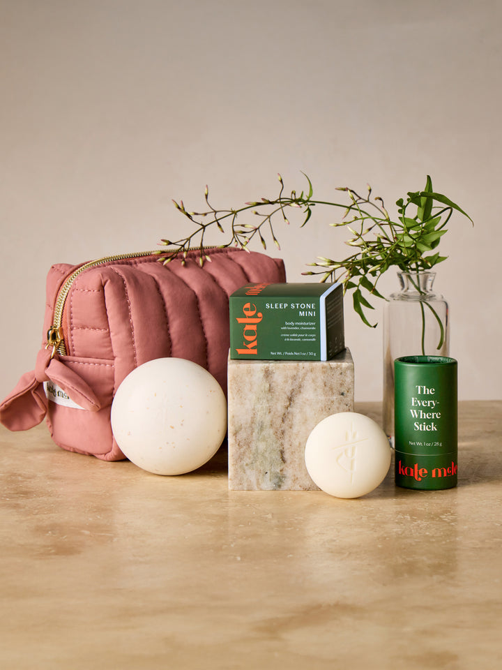 The complete jet set that includes the limited-edition mini travel bag in blush, the travel case, the mini sleep stone and the everywhere stick.