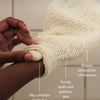 Hand using a textured body mitt with text describing its benefits.