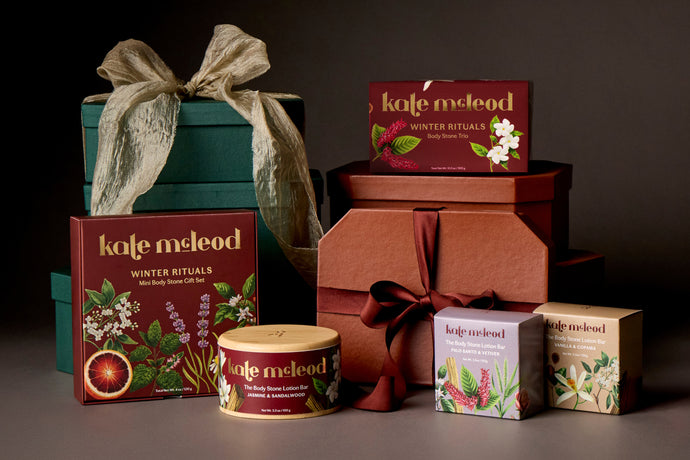 A group shot of Limited Edition Holiday and Fall items stacked together with gift boxes and bows against a dark gray background.