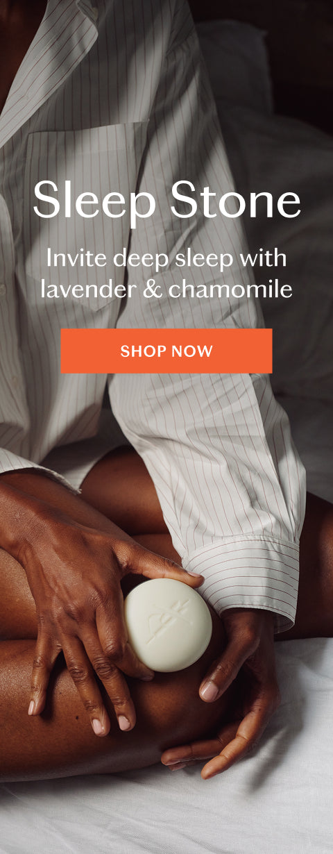 A person in a white pinstripe shirt holds a round white soap bar labeled 'Sleep Stone' over their knee, with large text reading 'Sleep Stone' and 'Invite deep sleep with lavender & chamomile' plus an orange 'SHOP NOW' button.