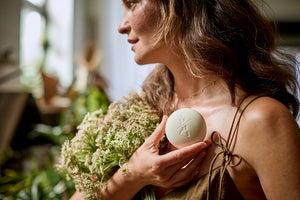 Woman holding bouquet and Body Stone.