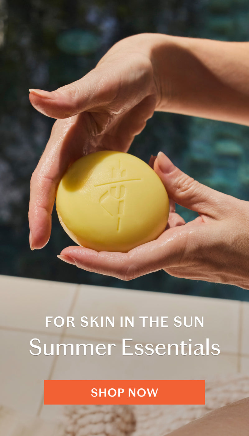 Hands holding Sun Stone with pool in background. Shop Summer Essentials.