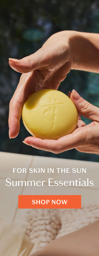 Hands holding Sun Stone with pool in background. Shop Summer Essentials.